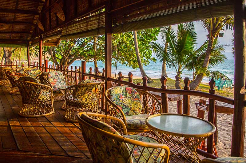 bar tables and chairs on the beach 